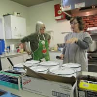 <p>CSI volunteers help cook Christmas dinner Tuesday at Ossining&#x27;s First Presbyterian Church.</p>