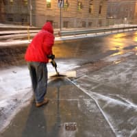 <p>A man shovels snow off Main Street in White Plains in front of Walmart on Wednesday. </p>