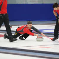 <p>Briarcliff Manor&#x27;s Bill Stopera, center, lines up his shot during the 2012 USA Curling National Championship in Aston, Pa. Stopera and his teammates won gold at the event. </p>
