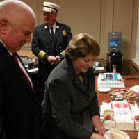 <p>Mayor Mary Foster cuts cake for Police Chief Eugene Tumolo. left, and Lenny Varella, who will both be leaving their position in January.</p>