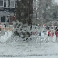 <p>Snow covers a front lawn Christmas display in White Plains. </p>