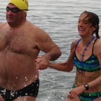<p>Robin Myers, left, and Andrea Williamson emerge from the waters off Compo Beach in Westport Tuesday morning following the Team Mossman Polar Plunge to benefit Save the Children.</p>