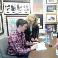 <p>New York Rangers defenseman Ryan McDonagh signs an autograph for a fan.</p>