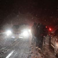 <p>Westchester Community College students attempt to weave through the cars on their walk to the bus stop during the November snow storm.</p>