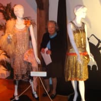 <p>Babs White with some of the dresses currently on display at &quot;Stepping Out in the Jazz Age&quot; at the Darien Historical Society.</p>