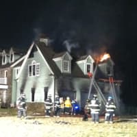 <p>A Bedford Hills home is engulfed in flames Tuesday night.</p>