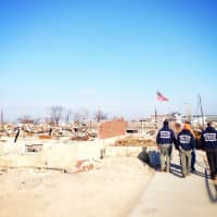 <p>Members of the Venture Crew from Lewisboro walk through the rubble in Breezy Point left by Hurricane Sandy.</p>