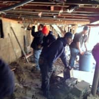 <p>The crew works to clear sand from the finished basement of one Sandy victim.</p>