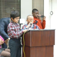<p>From left, Dennis Bailey, 9, and Earl McClellan, 11, ask the Greenburgh Town Board to pass their resolution, which would set four recycling bins in the Theodore D. Young Community Center.</p>