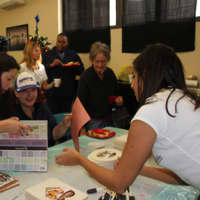 <p>New members of the JLCW in Scarsdale work on creative picture frames during the event.</p>