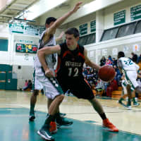 <p>A Norwalk player defends Ridgefield&#x27;s Jeff Racy in the paint.</p>