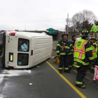 <p>Norwalk firefighters respond after a van flipped on its side on I-95 north Tuesday afternoon.</p>