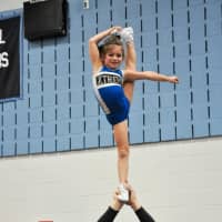 <p>Xtreme Cheer co-owner Mike Talbot holds a young gymnast aloft.</p>