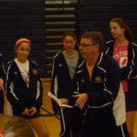 <p>Weston High School girls basketball coach talks to players at the camp as players on the high school team listen to his instructions.</p>