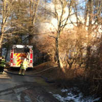 <p>Firefighters arrive at a blaze Tuesday afternoon at 42 Wood St. in Somers.</p>