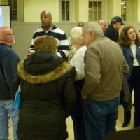 <p>Mike Chambers, Greenwich director of inland wetlands and watercourses, left, and Amy Siebert, Greenwich Commissioner of Public Works, right, speak with residents at Wednesday&#x27;s informational meeting on the Byram River flooding study.</p>