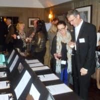 <p>The crowd checks out the silent auction during the fund-raiser for Green Streets at the Bedford Post Inn.</p>