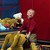 <p>First-grader Christopher Allesandrine plays with a giant stuffed horse during the tag sale at Ridgefield&#x27;s Scotland Elementary school.</p>