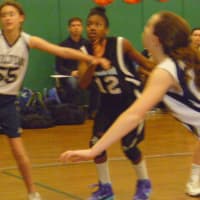 <p>Norwalk&#x27;s Sanaa Boyd, 12, goes for a rebound against Wilton.</p>