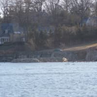 <p>An excavator got stuck in the sand and then the tide took it into Long Island Sound in Greenwich.</p>