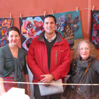 <p>Plum Plums owner Audrey Free, left, stands with Pound Ridge Elementary art teacher David Llanos, and local artist Lisl Steiner, who curated the art show.</p>