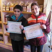 <p>Pound Ridge Elementary students Gerardo Tueme and Jennifer Paul show off their art certificates.</p>