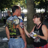 <p>Somers artist Jennifer Siciliano paints a 9/11 first responder at a Ground Zero 10th anniversary event.</p>