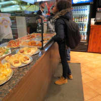 <p>A student grabs a slice at Blackboard after school. </p>
