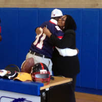 <p>Archbishop Stepinac High School tight end Tyrik Stovall hugs his mother after he officially committed to Marist College.</p>