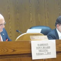 <p>Mayor Ron Belmont and Councilman Joe Cannella discuss the Harrison Public Library renovations with fellow board members and the community Thursday night.</p>