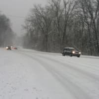<p>Cars drive slowly on Route 9 in Ossining Friday afternoon. </p>