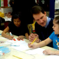 <p>U.S. Rep. Jim Himes gives students tips while they make Valentines. </p>