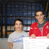<p>The Grippi brothers, Matt. left, and Tommy, right, celebrate Tommy winning the 145-pound Section 1 Large School wrestling title. Matt Grippi finished third at 106 pounds.</p>