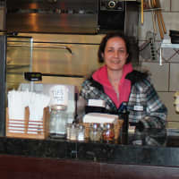 <p>Dobbs Ferry Pizza co-owner Alyssa Tacij stands behind her counter.</p>