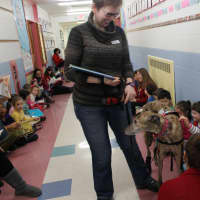 <p>Dobbs Ferry librarian Anne Quick introduces her greyhound to Springhurst students.</p>