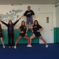 <p>Melissa  Mansi, center, shows off her special needs cheerleading team.</p>