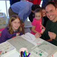 <p>Alec Geuttel helps his daughter Clara make some jewelry at Sparklers Design Studio in Pound Ridge.</p>