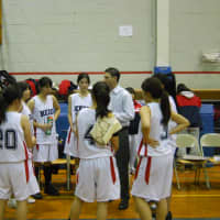<p>Keio coach Justin Loeb talks to the team after the girls defeated Solomon Schechter in a quarterfinal game of the Section 1 Class C Girls Basketball Championship. </p>