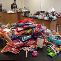 <p>Club members Jake Nivasch, a junior; and freshman Lou Borsellino help with the donations.</p>