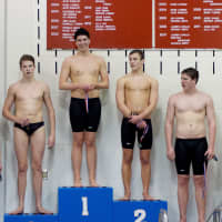 <p>Staples High&#x27;s Jonathan Blansfield stands on the top of the podium after setting a meet record in winning the 500 free at the league championships.</p>