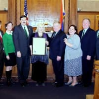 <p>Deborah Polhill (center) is honored for her community service during a celebration of Irish American Heritage Month by county legislators at their meeting Monday.</p>