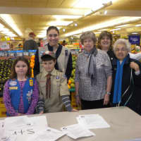 <p>Victoria McGuire (back left) gets some help at a food drive at Stop &amp; Shop from her young siblings Isabella (left), 6, and Christopher, 9.</p>