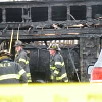 <p>Norwalk firefighters doused a detached garage fire at 42 Woodward Ave. Wednesday morning. One person was injured in the blaze, and one was being questioned.</p>