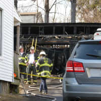 <p>Norwalk firefighters at the scene of the Wednesday morning garage fire on Woodward Avenue.</p>