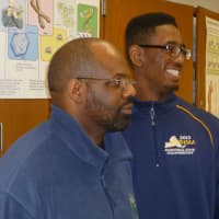 <p>Lewis Edney Jr., left, and his son Khalil Edney, a New Rochelle basketball and football student/athlete, shares with youngsters in Yonkers.</p>