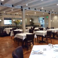 <p>Exposed wood beams decorate the dining room at 323 Main, a new restaurant in Westport.</p>
