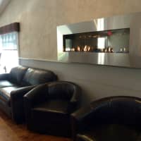 <p>The bar area at 323 Main in Westport boasts a wall-mounted gas fireplace.</p>
