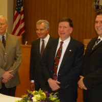 <p>Elmsford officials, from left, Trustee Sydney Henry, Justice Richard Leone, Mayor Robert Williams and Trustee Michael Eanazzo are sworn in Monday.</p>