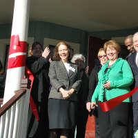 <p>A ribbon-cutting ceremony is held on the front porch of the house, located at 122 Nelson Ave.</p>