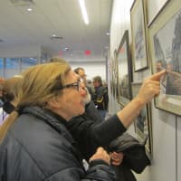 <p>Ossining residents examine photographs and artwork displayed at the Ossining Public Library honoring the Village of Ossining&#x27;s Bicentennial. </p>